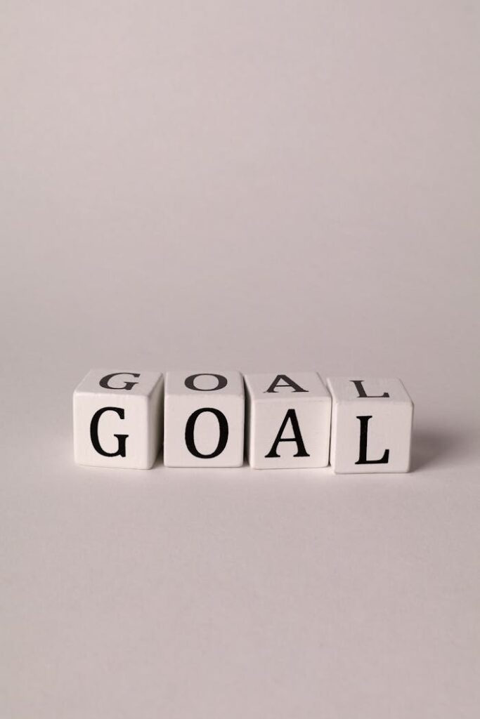Simple motivation concept with 'Goal' spelled on white cubes against a neutral background.